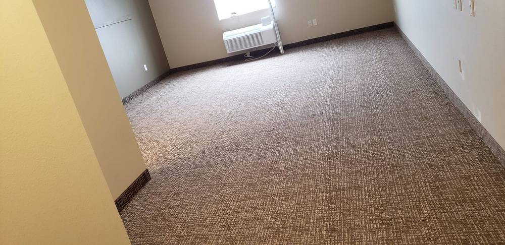 Freshly installed carpet in an empty room